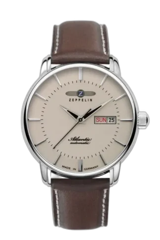 Stylowy zegarek Zeppelin Atlantic Automatic 8466-5 z kremową tarczą ozdobioną minimalistycznymi indeksami i eleganckimi wskazówkami. Na tarczy widoczny datownik z dniem tygodnia i datą na godzinie trzeciej, co dodaje mu funkcjonalności. Wyposażony w brązowy, skórzany pasek, który harmonizuje z klasycznym designem. Precyzyjnie wykonany w Niemczech, podkreślając niezawodność i kunszt marki Zeppelin. Idealny dla osób ceniących elegancję i prostotę.