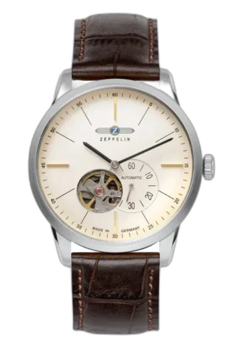Stylowy zegarek Zeppelin Flatline 7364-5 Automatik z minimalistyczną kremową tarczą i widocznym mechanizmem typu open-heart na godzinie 7. Wyposażony w smukłe wskazówki, subtelne indeksy oraz wskaźnik sekundowy. Elegancki brązowy pasek skórzany dopełnia klasyczny niemiecki design.