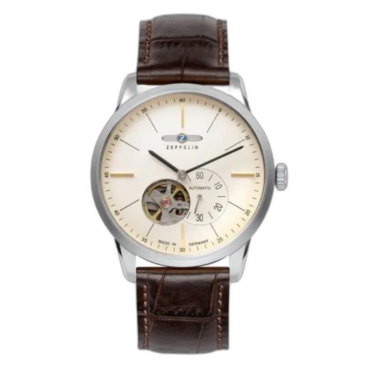 Stylowy zegarek Zeppelin Flatline 7364-5 Automatik z minimalistyczną kremową tarczą i widocznym mechanizmem typu open-heart na godzinie 7. Wyposażony w smukłe wskazówki, subtelne indeksy oraz wskaźnik sekundowy. Elegancki brązowy pasek skórzany dopełnia klasyczny niemiecki design.