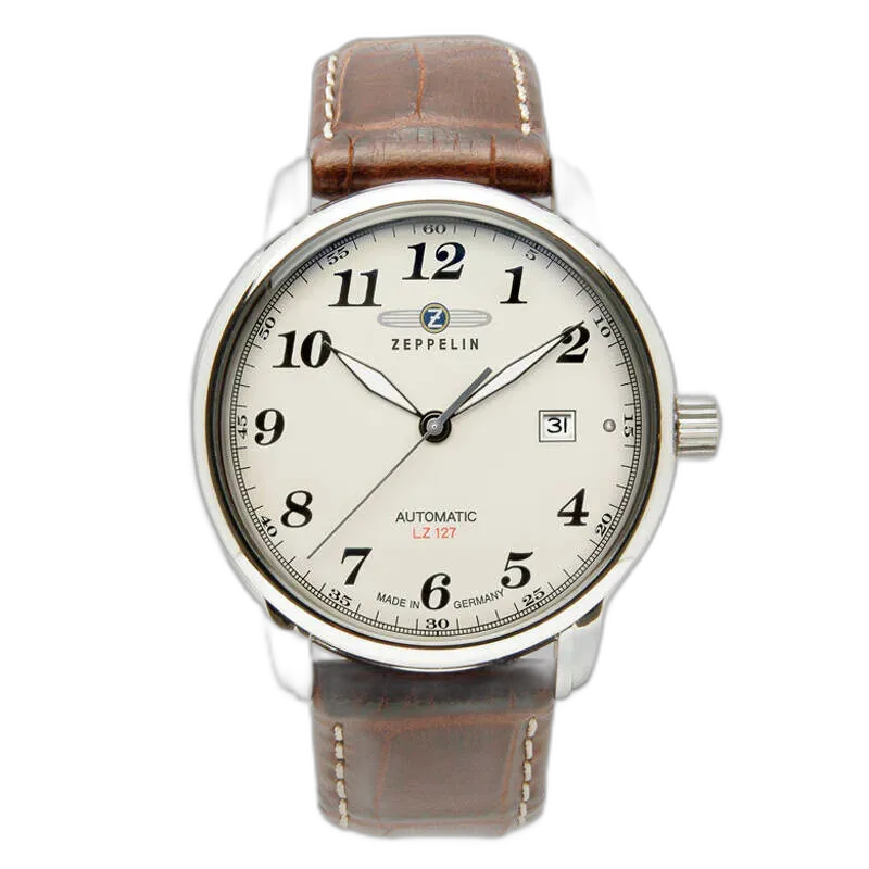 Elegancki zegarek Zeppelin LZ127 7656-5 Automatik z jasną tarczą i wyraźnymi cyframi arabskimi. Wyposażony w brązowy skórzany pasek z przeszyciami oraz okienko datownika na godzinie 3. Klasyczny design połączony z niezawodnym niemieckim mechanizmem automatycznym. Idealny wybór dla miłośników tradycyjnych czasomierzy.