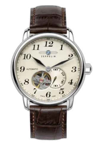 Wyrafinowany zegarek Zeppelin LZ127 7666-5 Automatik z kremową tarczą i widocznym mechanizmem typu open-heart na godzinie 7. Czasomierz wyposażony w wyraźne cyfry arabskie oraz brązowy skórzany pasek z eleganckimi przeszyciami. Niemiecki design łączy klasykę z nowoczesną technologią automatycznego mechanizmu.