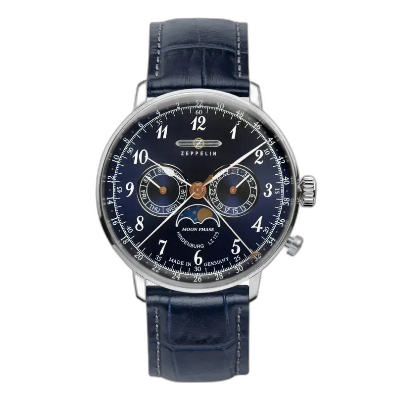 Stylowy zegarek Zeppelin LZ129 Hindenburg 7036-3 z granatową tarczą i funkcją faz księżyca. Wyposażony w subtelne wskazówki, datownik oraz wskaźniki dnia tygodnia i miesiąca. Elegancki granatowy skórzany pasek dodaje klasy i wyrafinowania. Niemiecka precyzja i ponadczasowy design.