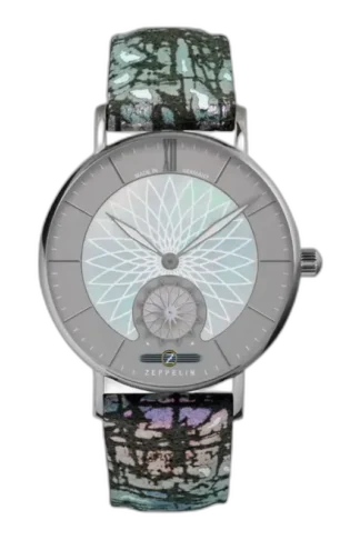 Wyjątkowy zegarek Zeppelin Mandala 8131-3 z unikalnym geometrycznym wzorem na srebrzystej tarczy, inspirowanym motywami mandali. Wyróżnia się niepowtarzalnym, wielobarwnym paskiem o artystycznym designie. Koperta wykonana z wysokiej jakości stali szlachetnej podkreśla nowoczesny i stylowy charakter zegarka. Precyzja wykonania w połączeniu z oryginalnym wzornictwem to esencja marki Zeppelin.